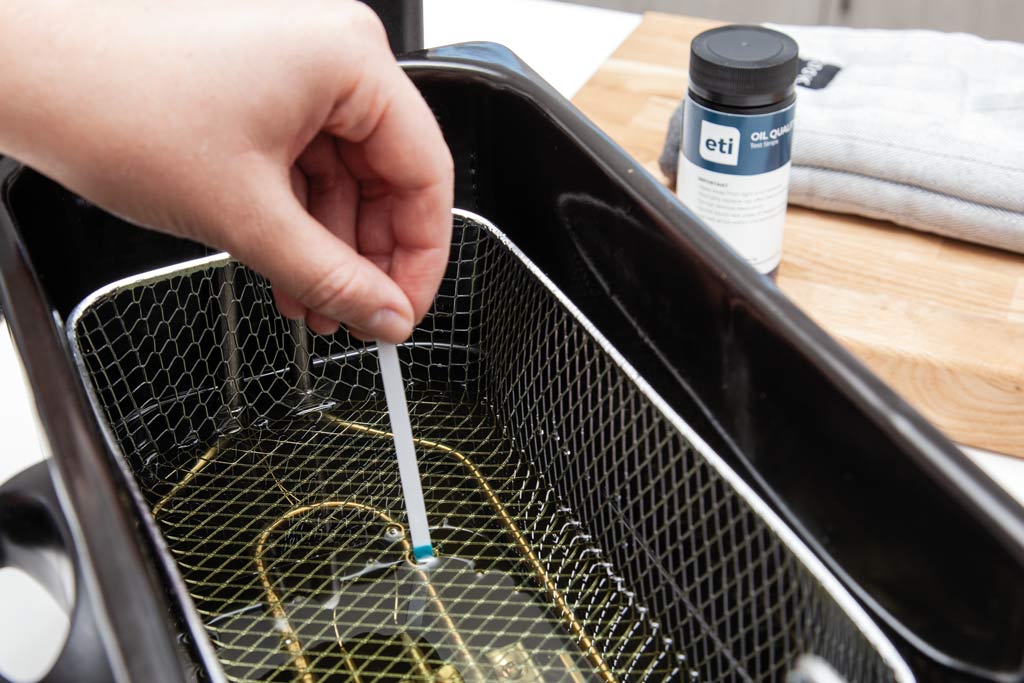 Frying oil quality being checked with test strips