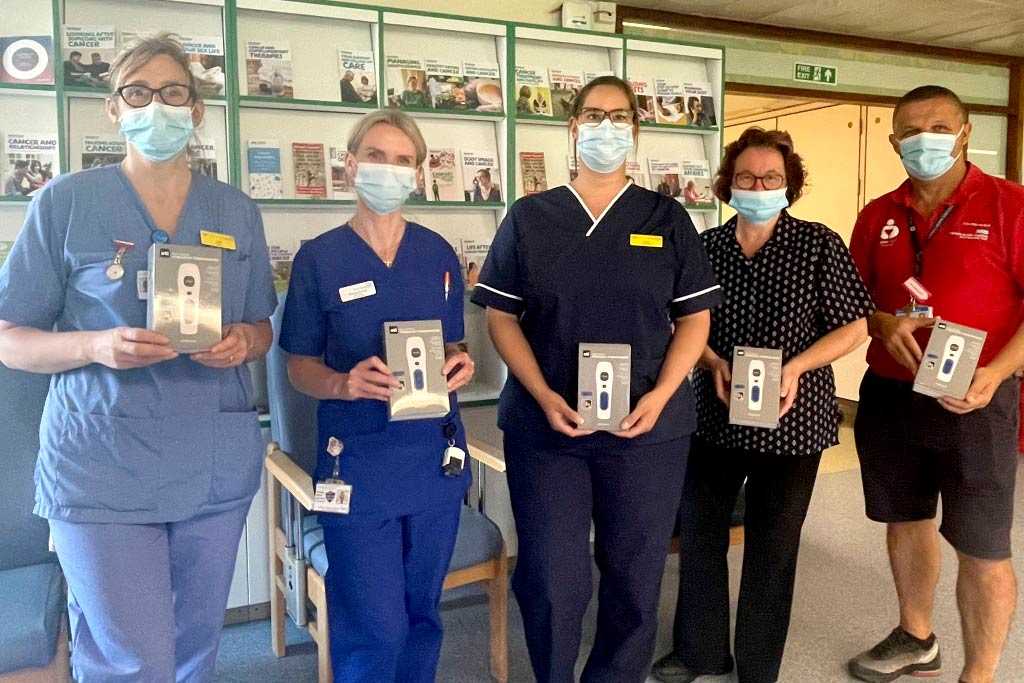NHS staff holding gifted infrared forehead thermometers from ETI