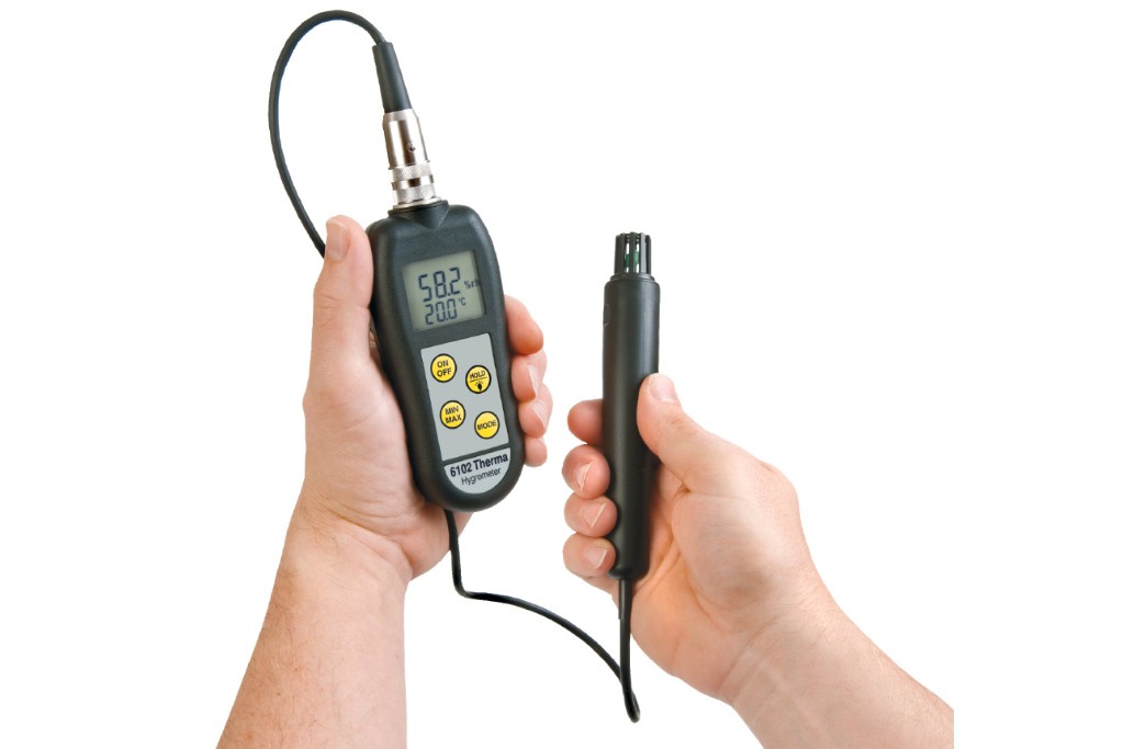 ETI 6102 therma-hygrometer and probe being held in two hands against a white background