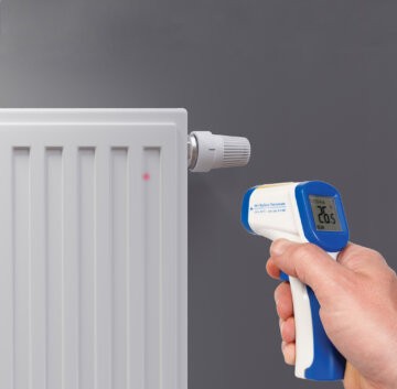 infrared thermometer measuring the temperature of a radiator