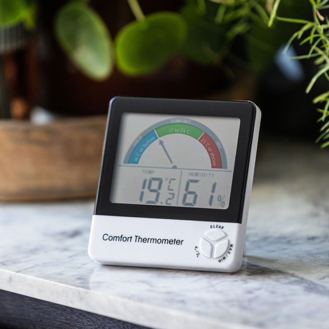 room thermoemter and hygrometer sitting on a marble counter